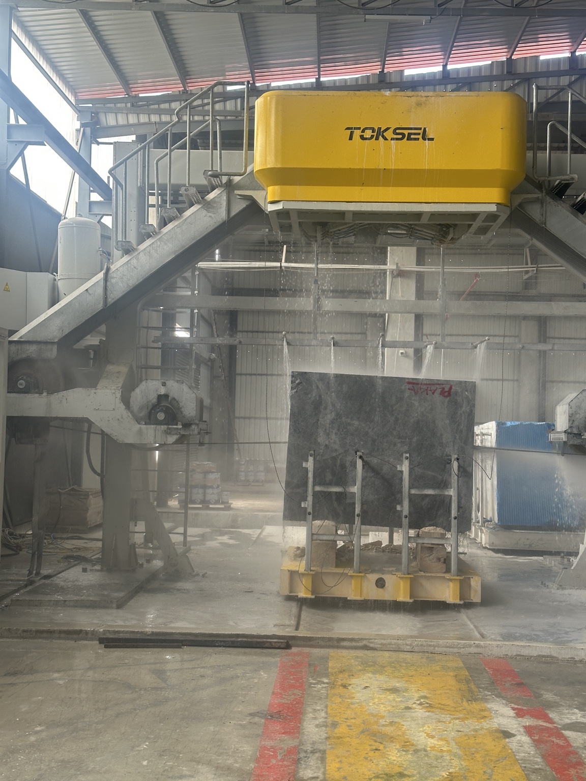 Multi-wire saw cutting a stone block at the workshop